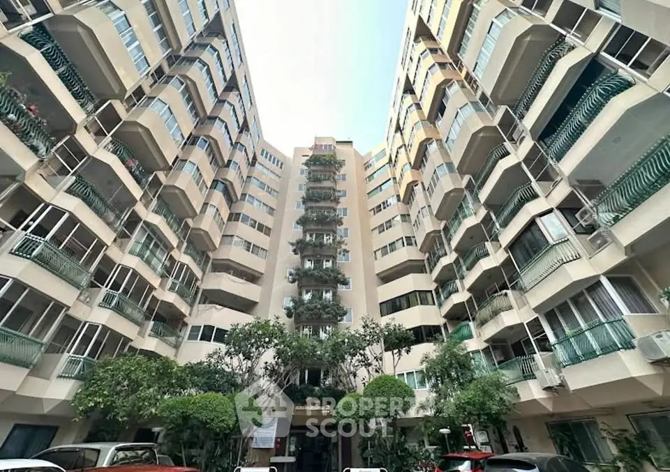 Stunning architectural view of a modern residential building with lush greenery.