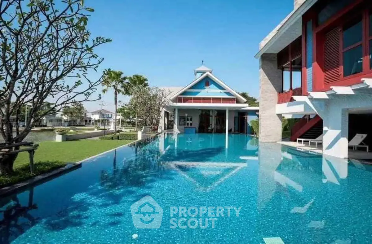 Luxurious property with stunning pool and modern architecture in serene setting.