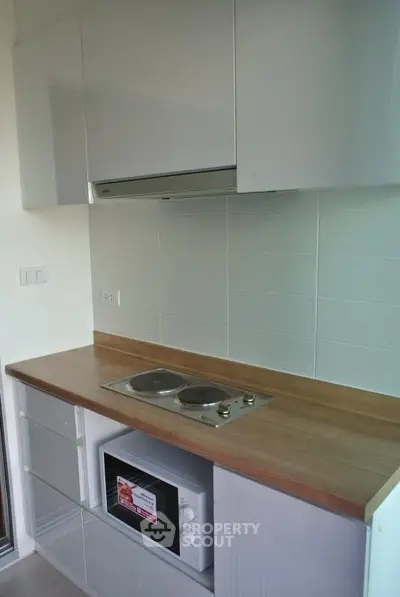 Modern kitchen with sleek cabinets and electric stove