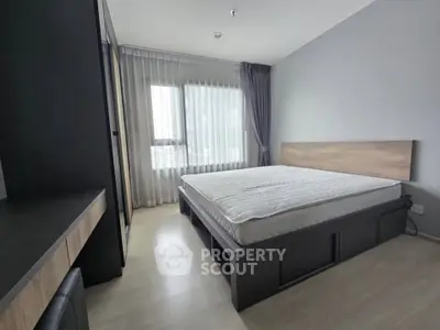 Modern minimalist bedroom with large window and sleek furnishings