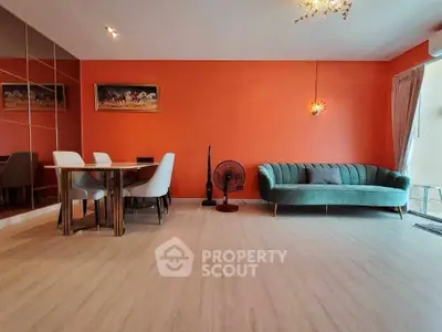 Stylish living room with vibrant orange wall and modern furniture