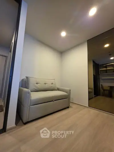 Modern living room with sleek design and cozy sofa, perfect for relaxation and comfort.
