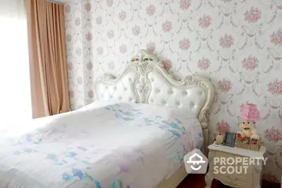 Elegant bedroom with ornate headboard and floral wallpaper, perfect for a cozy retreat.