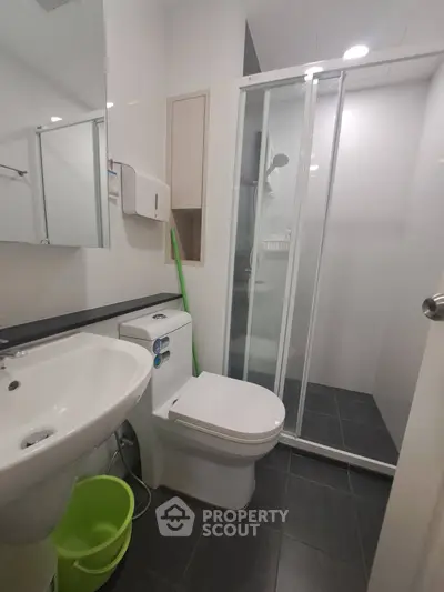 Modern bathroom with sleek shower and contemporary fixtures in stylish apartment.