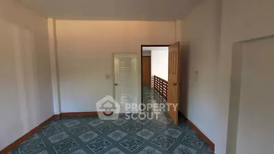 Spacious room with unique tile flooring and wooden accents