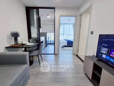 Modern apartment interior with open living room and kitchen, featuring stylish decor and natural light.