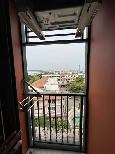 Stunning city view from a high-rise balcony with modern railing and laundry rack.