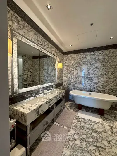 Luxurious marble bathroom with elegant freestanding bathtub and double vanity.