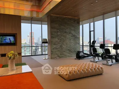 Luxurious gym with city view, modern decor, and state-of-the-art equipment in high-rise building.