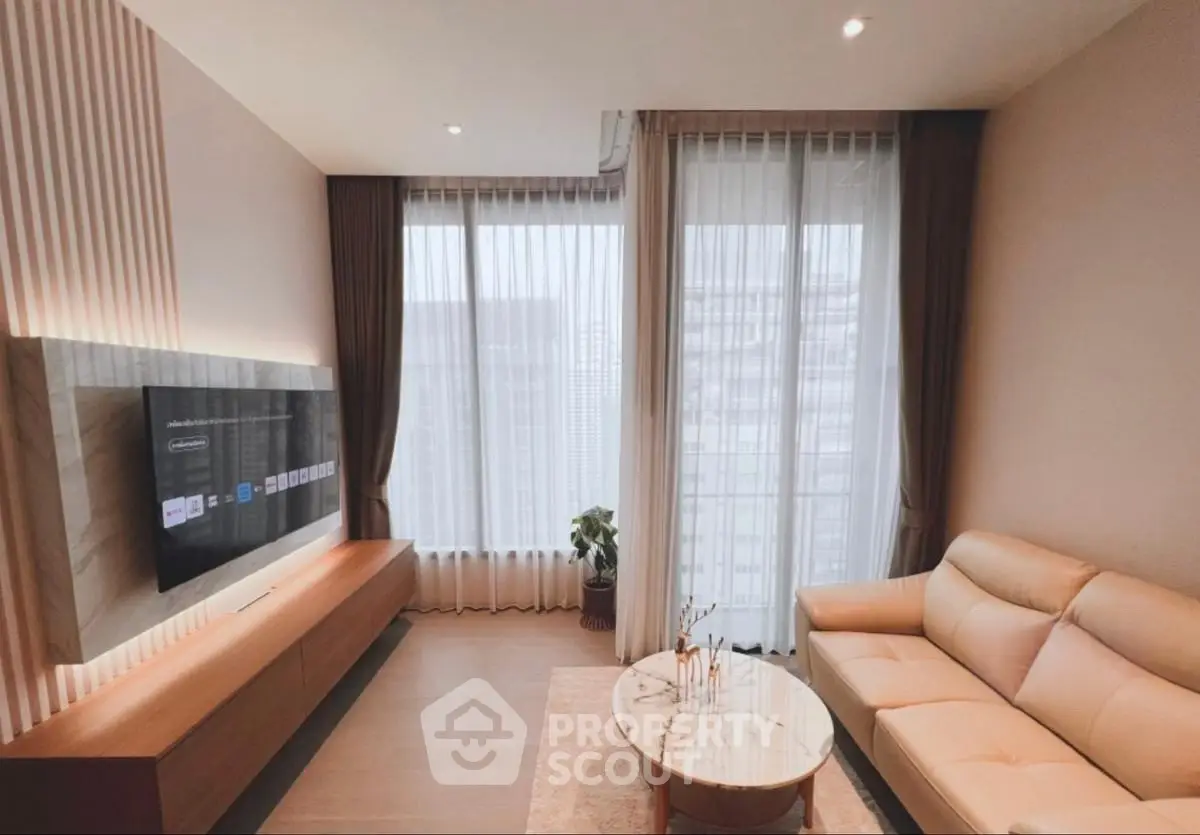 Modern living room with sleek design and large windows offering natural light.