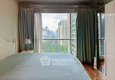 Spacious bedroom with stunning city view and large windows in modern apartment.