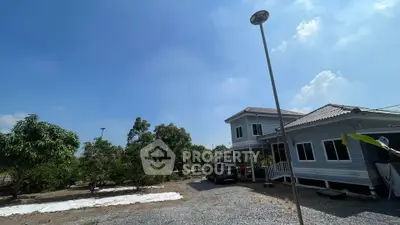 Charming suburban house with spacious garden and clear blue sky