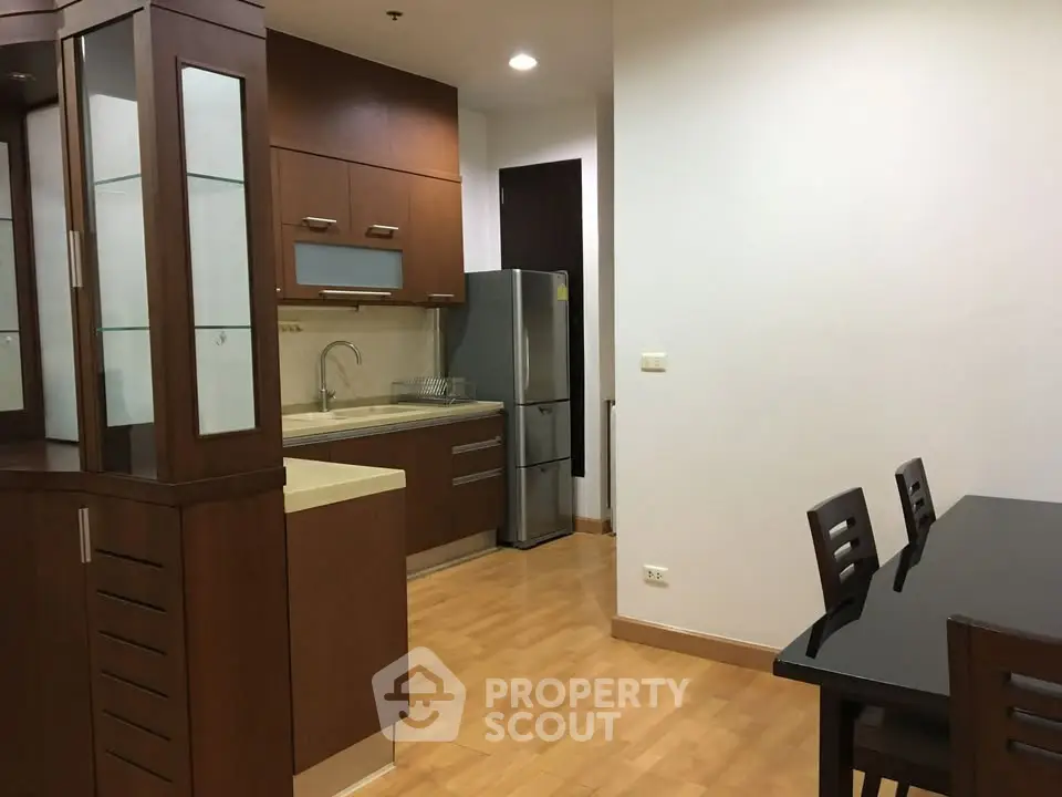 Modern kitchen with sleek cabinetry and dining area in a stylish apartment