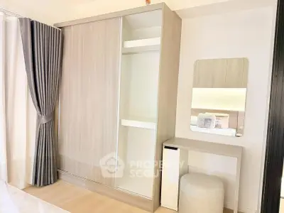 Modern bedroom with sleek wardrobe and stylish vanity area, perfect for contemporary living.
