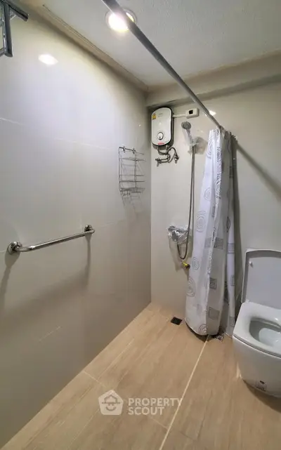 Modern bathroom with shower curtain and water heater in sleek design