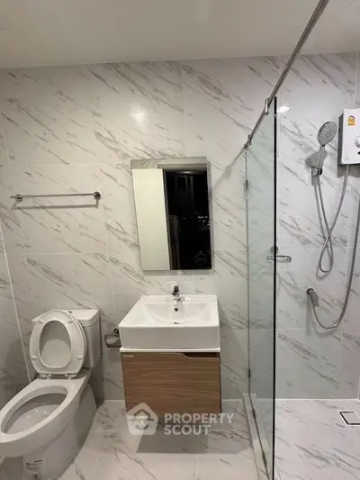 Modern bathroom with sleek fixtures and glass shower enclosure