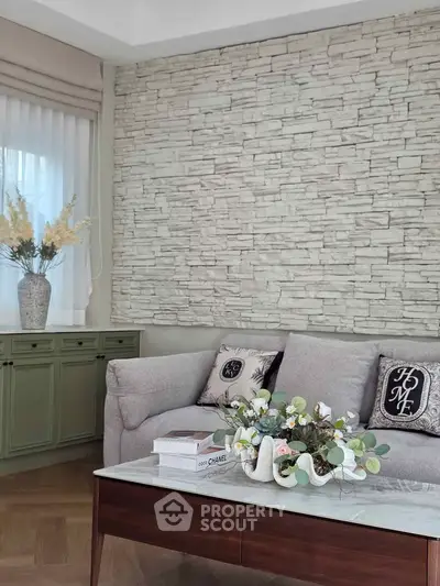 Elegant living room with stone accent wall and stylish decor