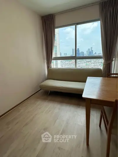 Bright living room with city view, featuring a cozy sofa and wooden dining table, perfect for urban living.