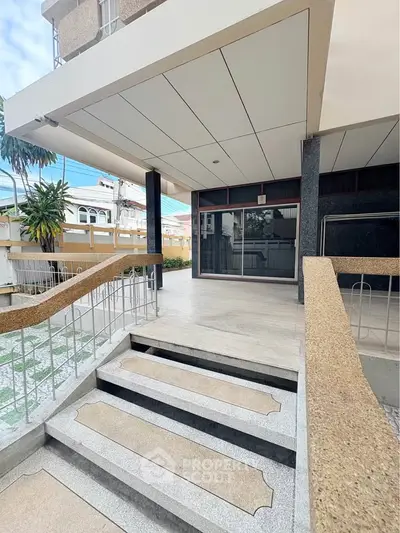 Modern building entrance with sleek design and accessible ramp