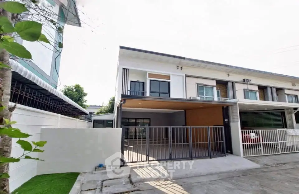 Modern townhouse exterior with gated parking and sleek design