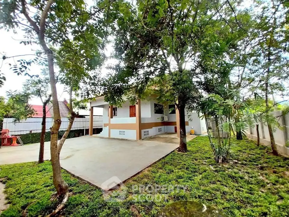 Charming single-story home with lush garden and spacious driveway, perfect for serene living.