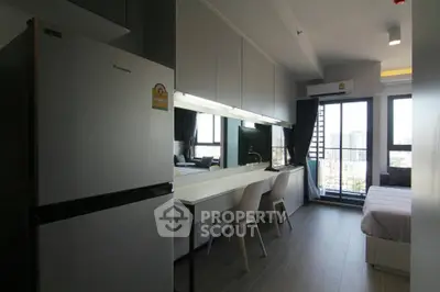 Modern studio apartment with sleek kitchen and city view