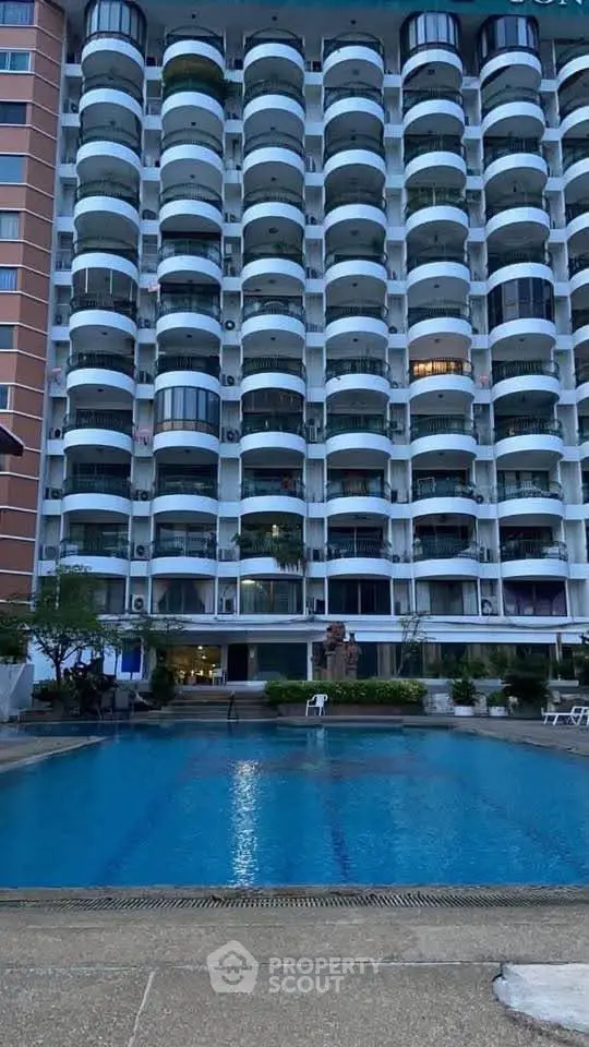 Stunning apartment building with pool view, perfect for luxury living.