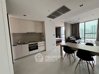 Modern open-plan kitchen and living area with sleek design and city view.