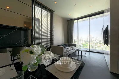 Modern living room with city view, elegant decor, and dining setup in luxury apartment.