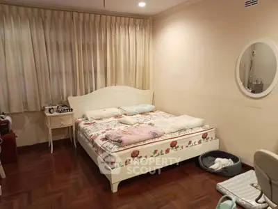 Cozy bedroom with elegant wooden flooring and stylish bed, perfect for restful nights.
