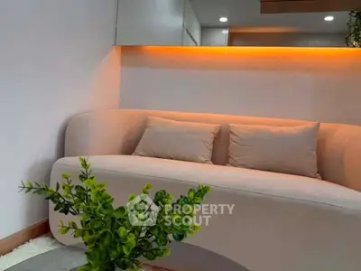 Modern living room with stylish sofa and ambient lighting