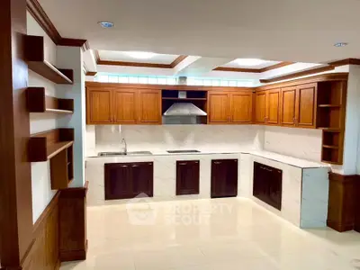 Spacious kitchen with wooden cabinets and modern design