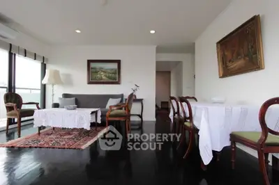 Spacious living room with elegant decor and large windows offering natural light.