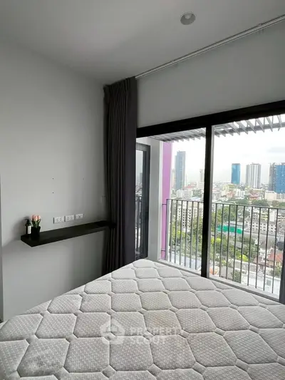 Modern bedroom with city view and large window balcony access in urban apartment
