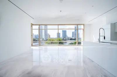 Spacious modern living room with panoramic city view and sleek white interior design.