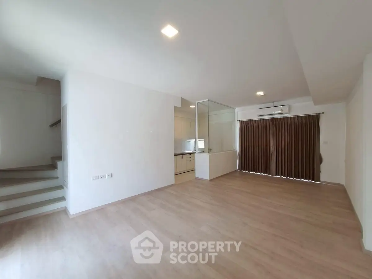 Spacious modern living room with open layout and wooden flooring