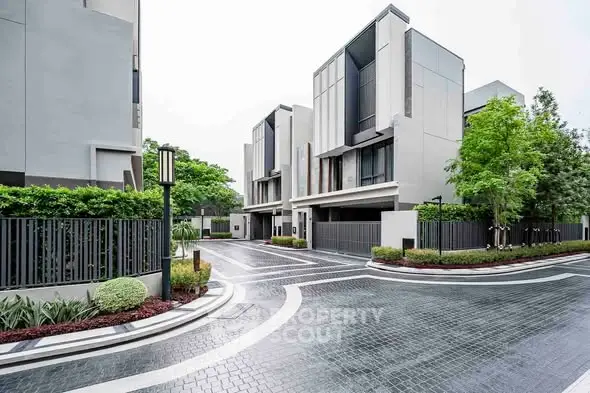 Modern townhouse complex with sleek architecture and lush greenery.