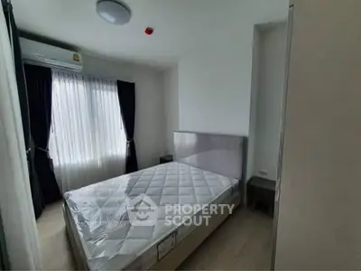 Modern bedroom with natural light and minimalist decor, featuring a comfortable bed and stylish curtains.