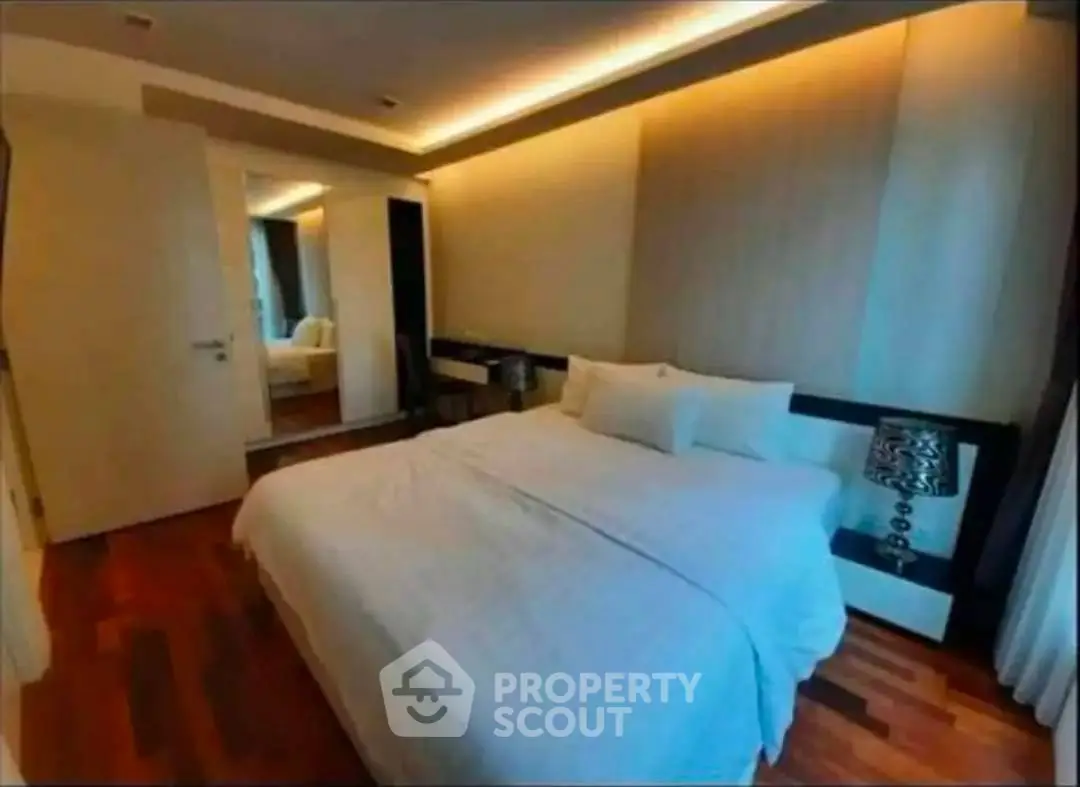 Luxurious bedroom with elegant lighting and modern decor in upscale apartment