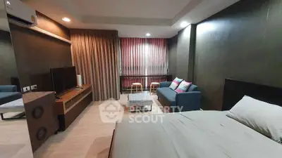 Modern bedroom with cozy seating area and stylish decor