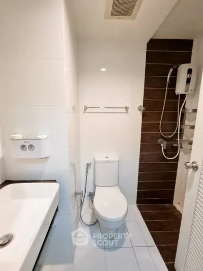 Modern bathroom with sleek fixtures and shower in contemporary apartment.