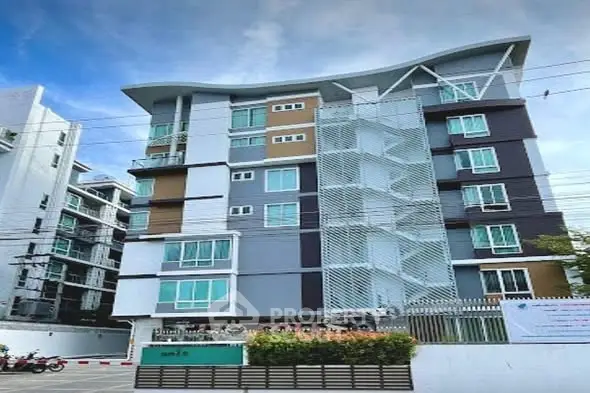 Modern multi-story apartment building with unique architectural design and vibrant exterior colors.