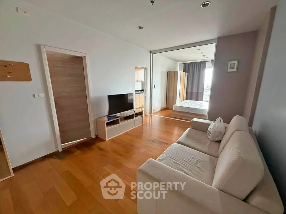 Spacious open-plan living room with wooden flooring and modern furnishings