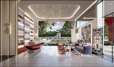 Luxurious modern lobby with elegant seating and artistic decor, featuring floor-to-ceiling windows and garden view.