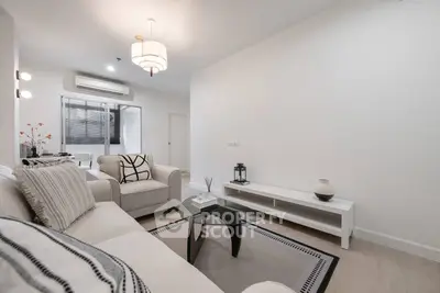 Modern living room with stylish decor and neutral tones, featuring a cozy sofa and elegant lighting.