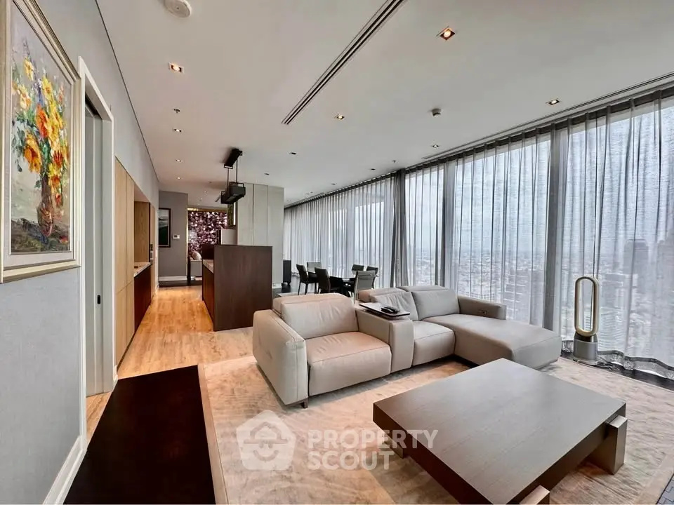 Luxurious modern living room with panoramic city views and elegant furnishings.