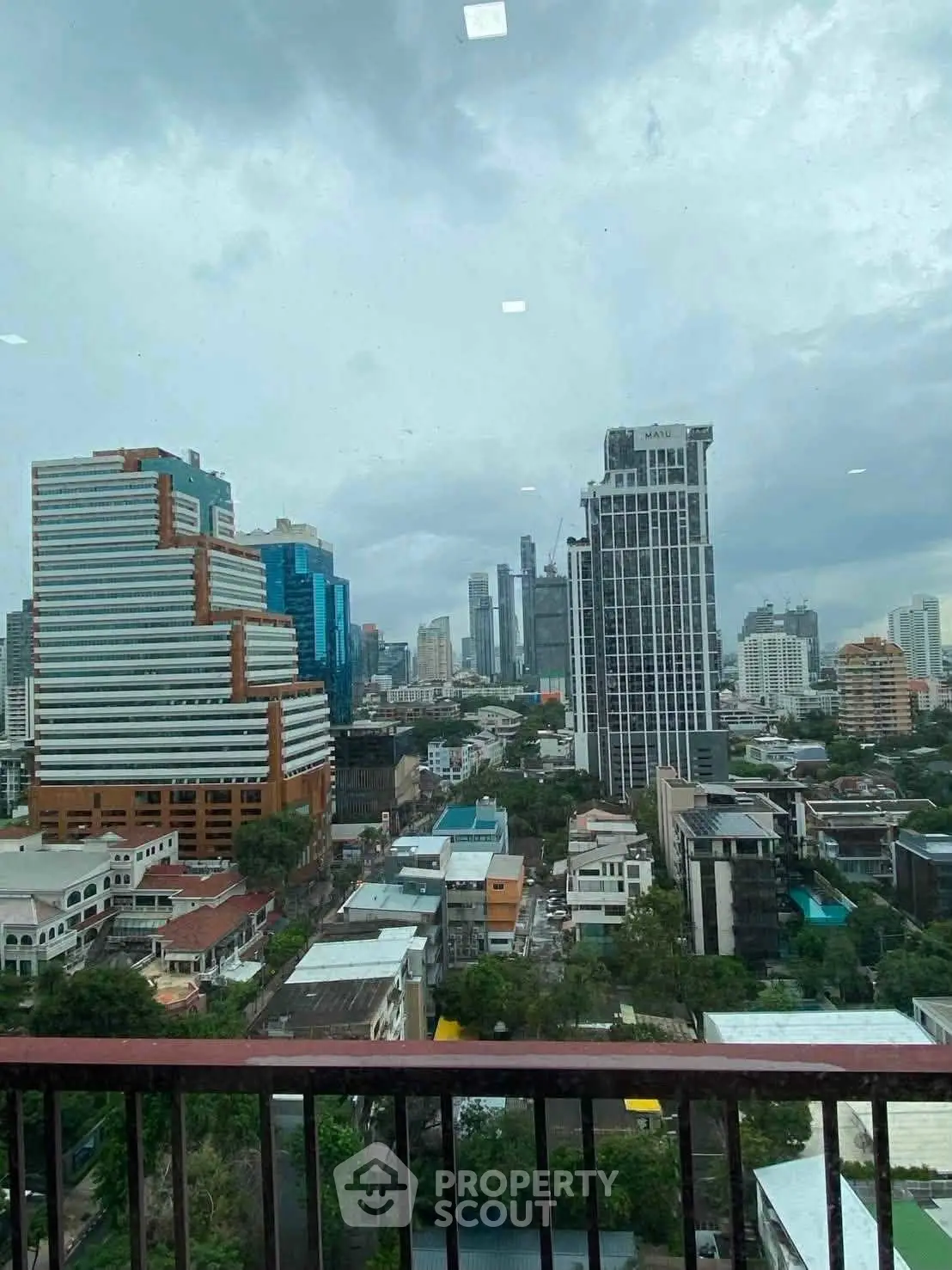 Stunning cityscape view from a high-rise balcony showcasing urban skyline and modern architecture.