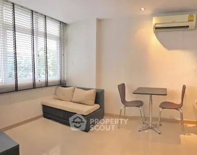 Modern living room with sleek furniture and air conditioning in a bright apartment.