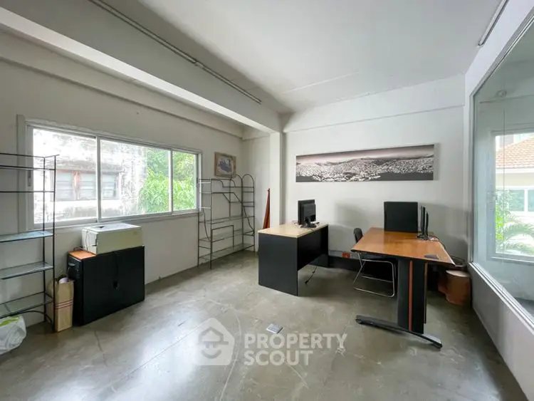 Spacious study room with modern desk and large window view