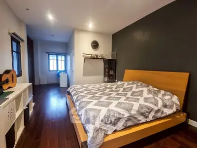 Spacious modern bedroom with stylish decor and natural light